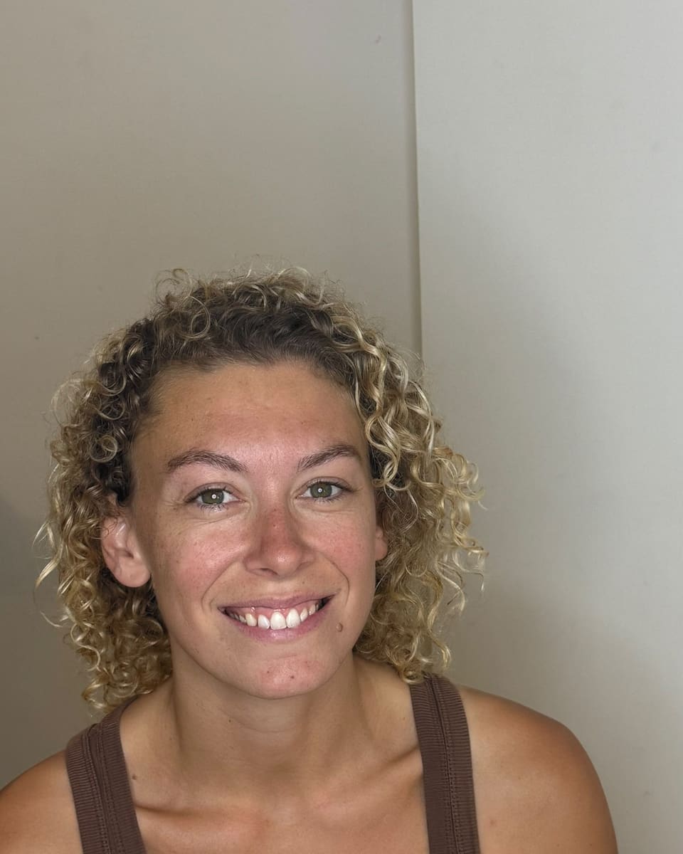 Before: curly blonde hair, no makeup