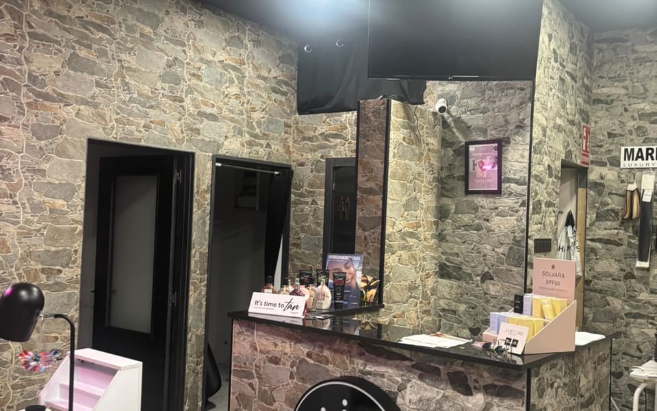 Reception as you walk in: stone walls, the Bronzed desk with its round lightbox, and the doors through to the rooms